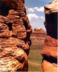 Colorado photography / Camel Rock Photography: ”Eye of the Needle”.  Here is Grabo' photography of camel Rock (Chimney Rock) viewed through a crack in the no-name cliffs opposite it.  Colorado, on the Wyoming border.  Northwest of Ft. Collins; Southwest of Laramie.